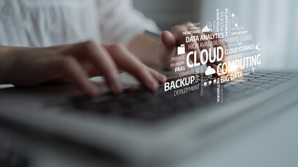 A person typing on a laptop with visual representations of cloud computing terms. This image highlights the importance of digital connectivity and data analytics in modern tech. Tessel