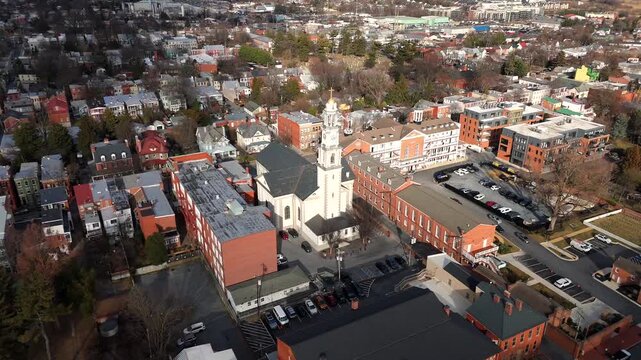 Aerial top view of church tower surrounded by residential area parking and trees in Maryland