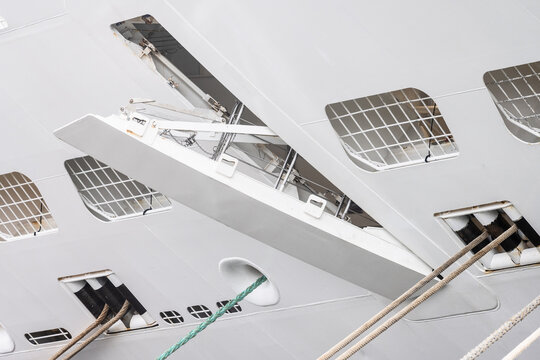 Cruise ship lifeboat deployment mechanism and hull details.