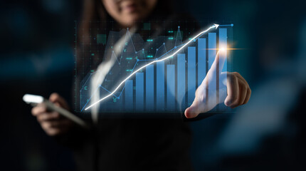 A professional in business attire engages with digital graphs illustrating upward trends, representing growth and success in a modern work environment. Impute