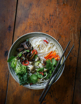 Vegetarian Pho Noodle Soup with Mushrooms, Vegetables, and Chopsticks