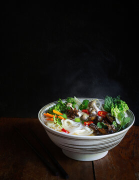 Vegetarian Pho Noodle Soup in Bowl on Dark Background