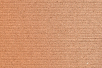 Fototapeta premium Natural brown kraft paper texture background with subtle horizontal grain and recycled fiber details. Minimal cardboard surface ideal for packaging design, eco branding, stationery, mockups, posters.