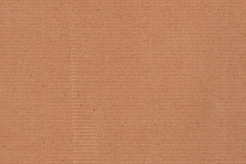 Fototapeta premium Natural brown kraft paper texture background with subtle horizontal grain and recycled fiber details. Minimal cardboard surface ideal for packaging design, eco branding, stationery, mockups, posters.