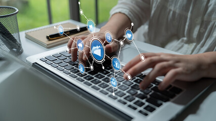 A focused individual engages with a laptop, surrounded by a bright workspace. Digital data visualization elements represent analysis and productivity in a modern setting. Tessel