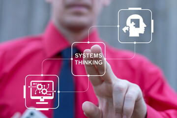 Business person using virtual touch screen presses the text SYSTEMS THINKING. Systems thinking...