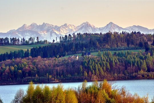 Landscape in the Pieniny Mountains, showing a lake and the rocky peaks of the Tatra Mountains in spring