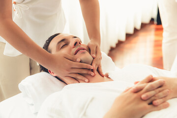 Caucasian man enjoying relaxing anti-stress head massage and pampering facial beauty skin...