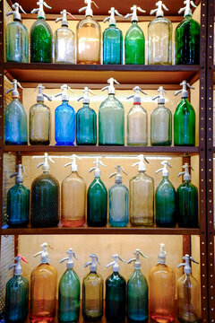 Paris, France, EU Many colorful selzer bottles lined up on a shelf.