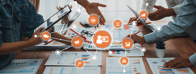 A modern workspace showcasing collaborative marketing strategies with hands engaged in discussion, analyzing data, and presenting ideas through various digital tools and documents. Amity