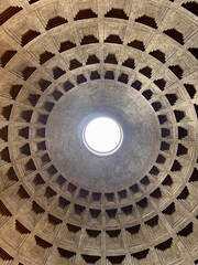 Interior dome of the Pantheon in Rome, ancient Roman temple ceiling with coffered concrete pattern and central oculus opening to the sky, classical architecture landmark and historic monument in Italy © Svar