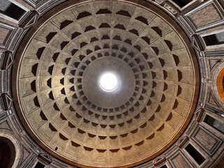 Interior dome of the Pantheon in Rome, ancient Roman temple ceiling with coffered concrete pattern and central oculus opening to the sky, classical architecture landmark and historic monument in Italy