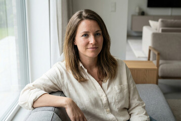 Woman Sitting on Sofa at Home in Natural Light