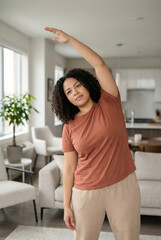 Woman Stretching Arm at Home During Light Exercise