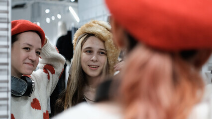Two teenage friends are shopping for warm winter clothes.