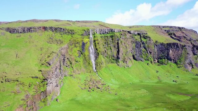 Aerial of a generic waterfall in Iceland falling over steep cliffs.