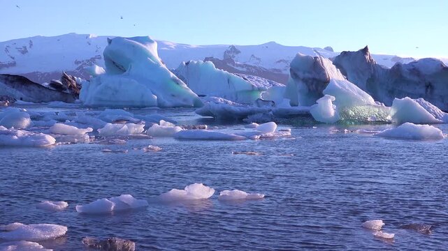Ice floats in the frozen Arctic, Jokulsarlon, glacier lagoon in Iceland, suggesting global warming.