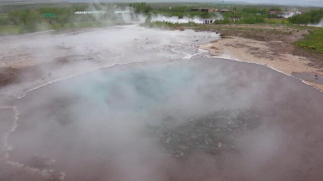 A hot boiling pool of water in a geothermal region of Iceland near Strokkur geyser.