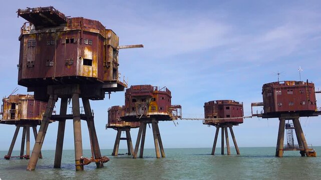 The Maunsell Forts, old World War two structures stand rusting on stilts in the Thames River Estuary in England.