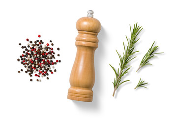 Top view of wooden pepper grinder with mixed black, red and white peppercorns and fresh rosemary...