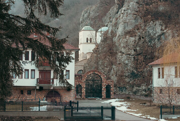 Gornjak Monastery surrounded by rocky cliffs and forest in the Gornjak Gorge, Eastern Serbia. Traditional Serbian Orthodox monastery located in a scenic mountain valley, symbolizing spirituality, hist