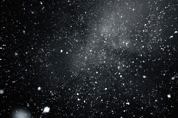 Obraz premium Black background with sparkling particles floating, simulating snow or stardust
