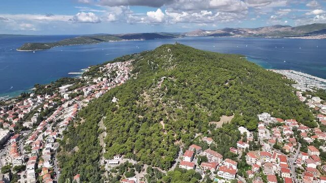 Drone view from above Marjan Hill showing pine trees, coastline, and panoramic view of Split city.