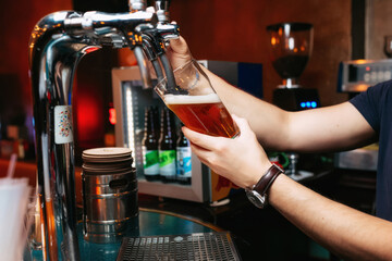 Crafting a cold beer at a local bar with a wide selection of drinks and lively atmosphere