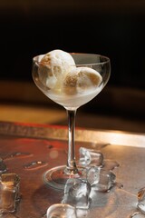 Dessert served in a glass with ice on a tray showcasing modern culinary presentation and refreshment