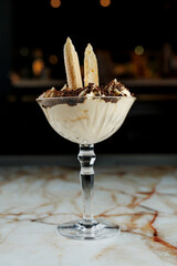 Delicious dessert made with cream, cookies, and chocolate served in a glass bowl