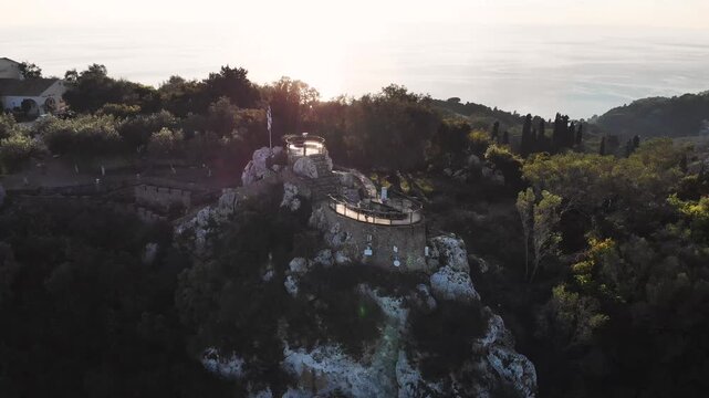 Kaiser's Throne observation deck lookout, Pelekas village, Corfu island, Greece, Kaiser William II summit Observatory panoramic sunny view with mountains, Ionian sea and Kerkyra city in the background