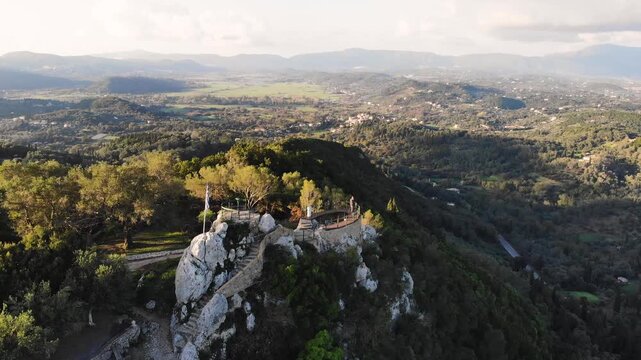 Kaiser's Throne observation deck lookout, Pelekas village, Corfu island, Greece, Kaiser William II summit Observatory panoramic sunny view with mountains, Ionian sea and Kerkyra city in the background