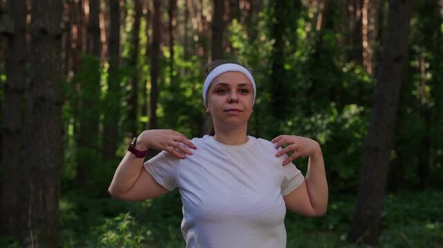 A woman exercises outdoors in a forest setting on a sunny day to improve fitness and health