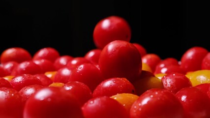 Wet cherry tomatoes falling in slow motion