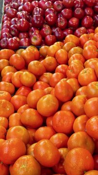 Vertical shot of colorful oranges and red apples. Details of the Turkish Market at Maybachufer. Berlin, Germany