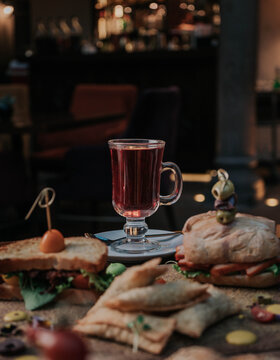 Elegant tea time with assorted cakes, pastries and light bites served alongside a warm cup of tea, perfect for afternoon relaxation and hospitality concepts.