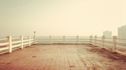 Naklejka premium Rooftop Terrace Overlooking Cityscape, Featuring Decorative White Fence and Tiled Surface on a Sunny Day