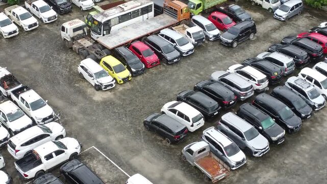 Aerial view of a parking lot lined up with cars for rent