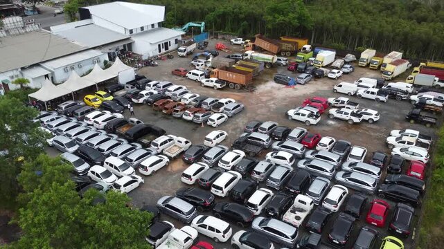 Aerial view of cars parked in a row for auction, there are various types of cars