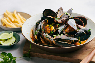 Coconut Curry Mussels in ceramic plate, selective focus