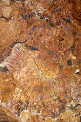 Naklejka premium Stone structures and grain patterns in reddish brown
