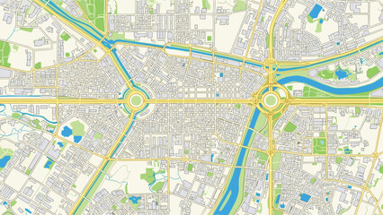 Fototapeta premium Top down view of a detailed city map features a network of roads, roundabouts, green parks, and urban buildings near a blue river.
