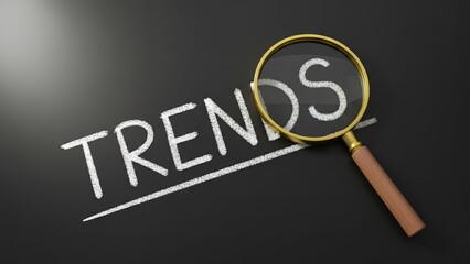 Magnifier focusing on the word trend against a blackboard representing trend analysis for branding innovation.