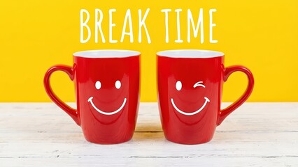 Two red mugs with smiling faces on a white table against a bright yellow background for break time.