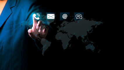 Businessman pointing at digital contact icons with a world map background. Concept of global communication customer support center, and international business connectivity network.