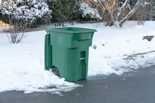 trash bin on the driveway after snow removed
