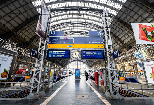Deutsche Bahn ICE 3 and SNCF TGV trains stopping at platform of Frankfurt am Main Hauptbahnhof (Central Station) behind the signages and information display panel in FRANKFURT, GERMANY on SEP 24, 2019