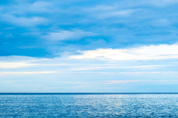 Obraz premium Panorama of clear sky and summer sea water background for summer vacation concept.with sunlight of beautiful cloudy blue sky with white altocumulus clouds.with 