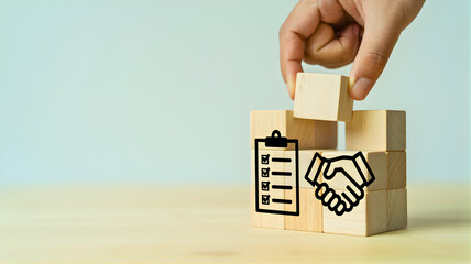 Hand using scissors to cut out one person icon from a line of figures, representing job cuts or restructuring