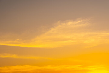 Fototapeta premium Panorama of dramatic golden sunset sky with dark storm clouds and sun rays, cinematic nature background 